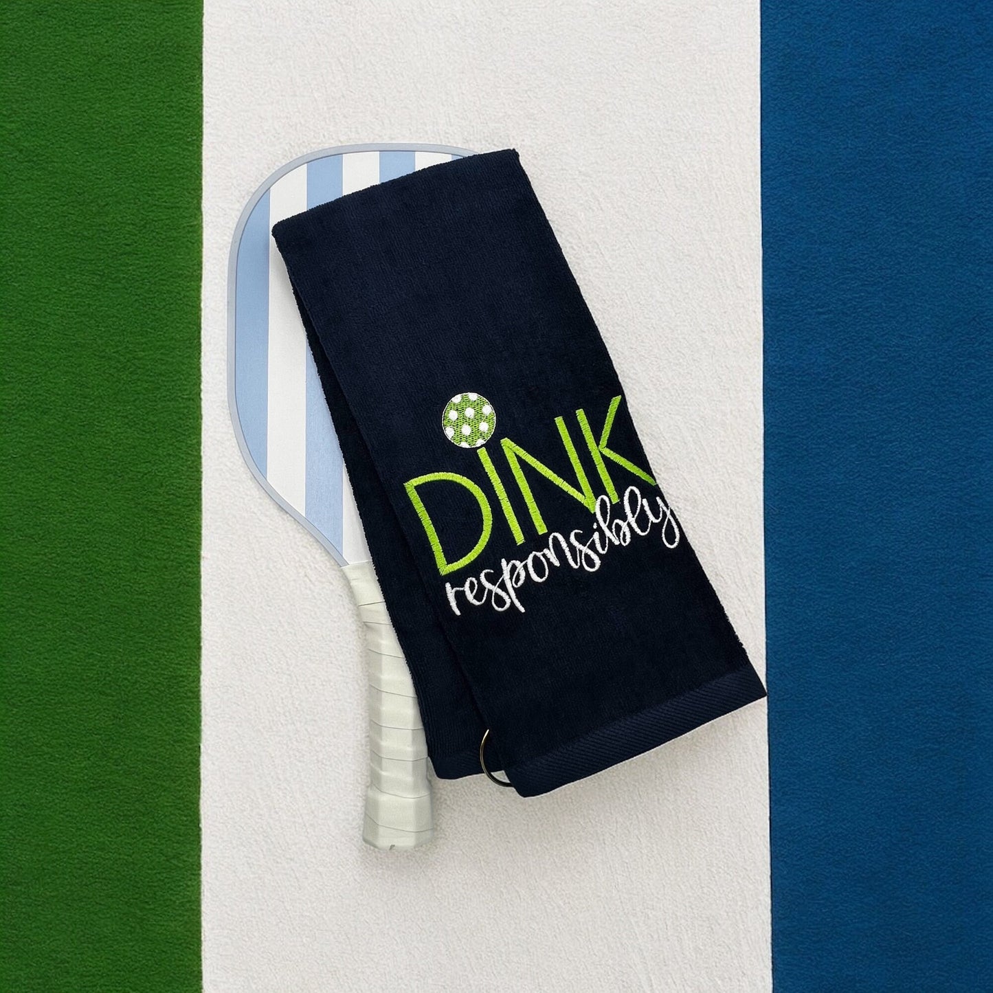 Custom embroidered navy towel with the phrase 'Dink Responsibly' in yellow and white, perfect for pickleball players.
