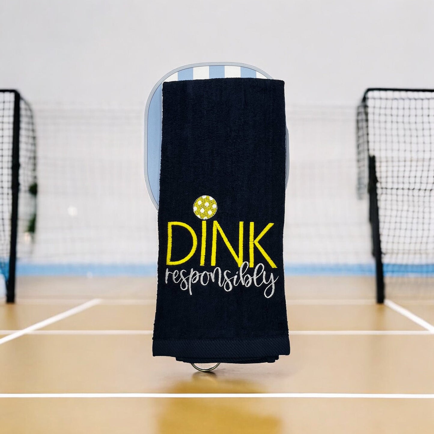 Custom embroidered navy towel with the phrase 'Dink Responsibly' in yellow and white, perfect for pickleball players.