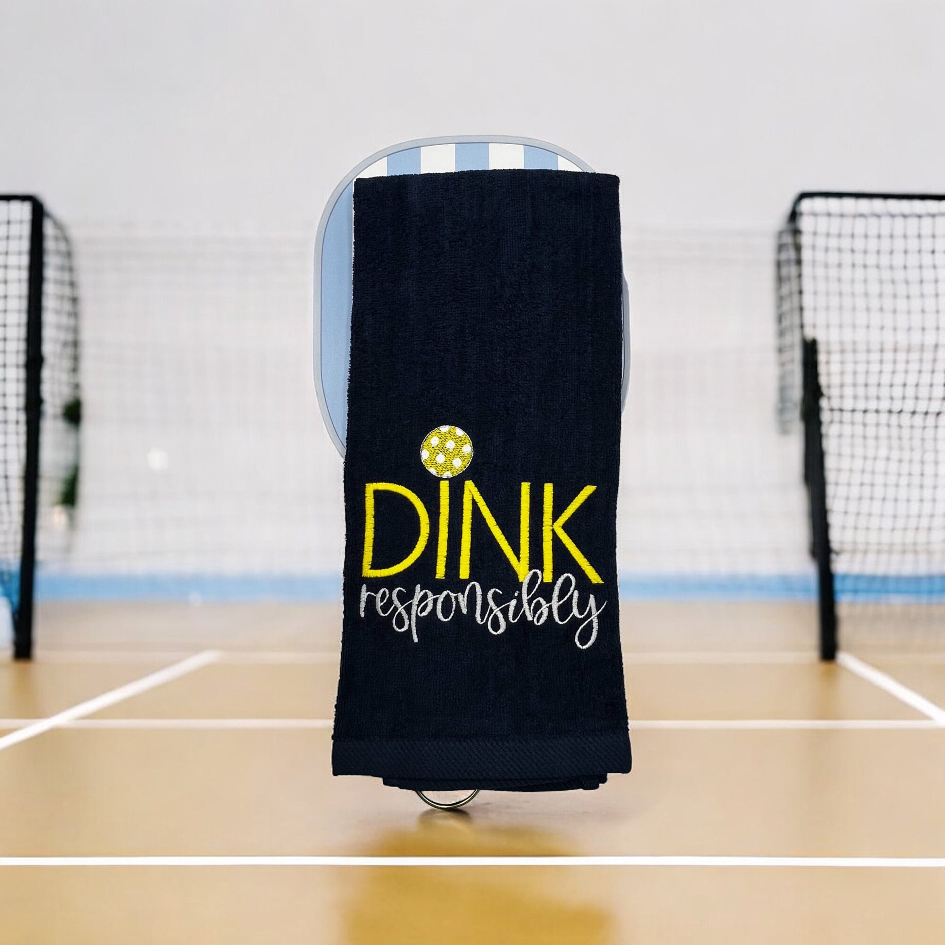Custom embroidered navy towel with the phrase &#39;Dink Responsibly&#39; in yellow and white, perfect for pickleball players.
